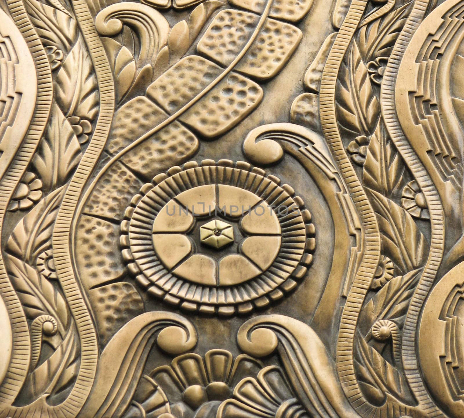 Abstract floral design carved into the brass exterior of a building