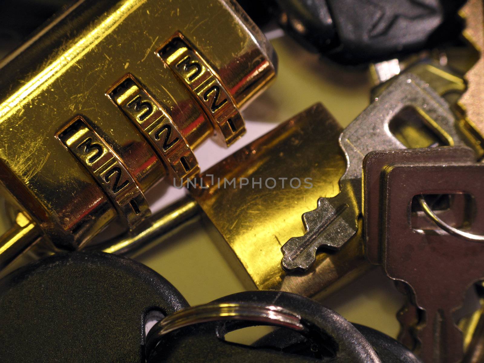 Closeup of a combination lock and miscellaneous keys