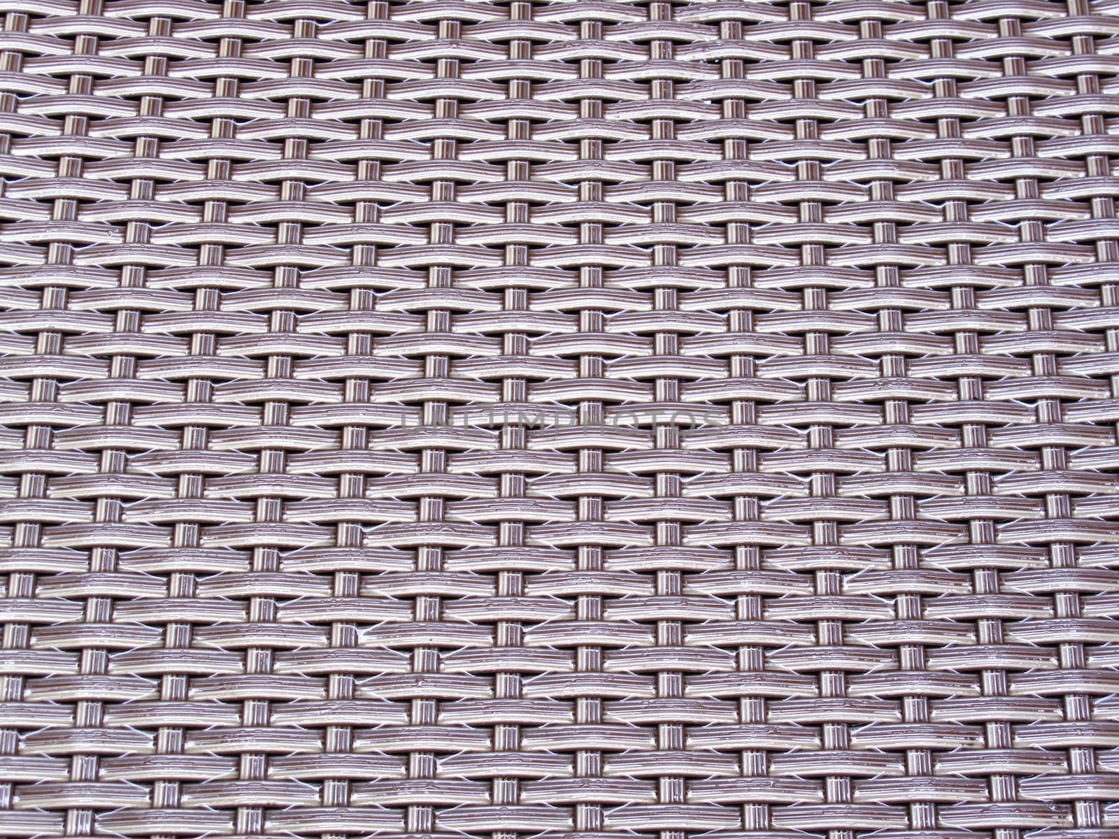Close-up of woven plastic chair after the rain