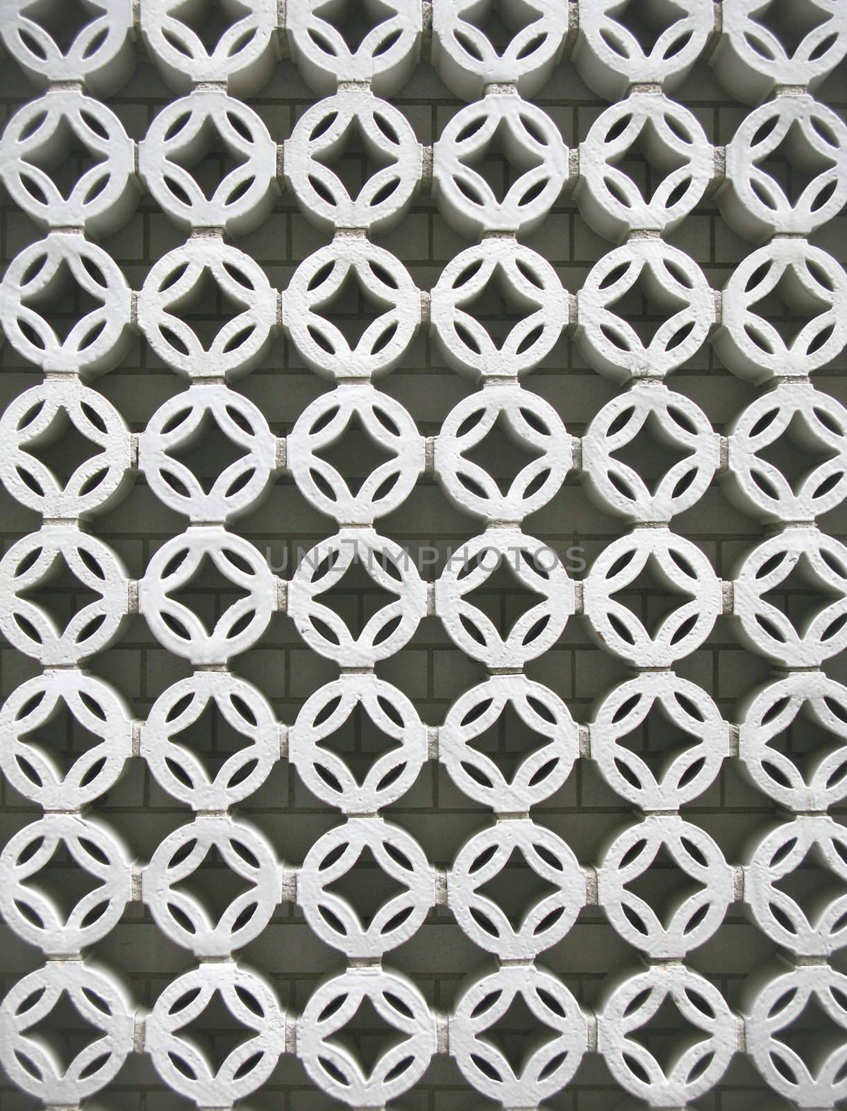 Lattice on side of building in white circular pattern