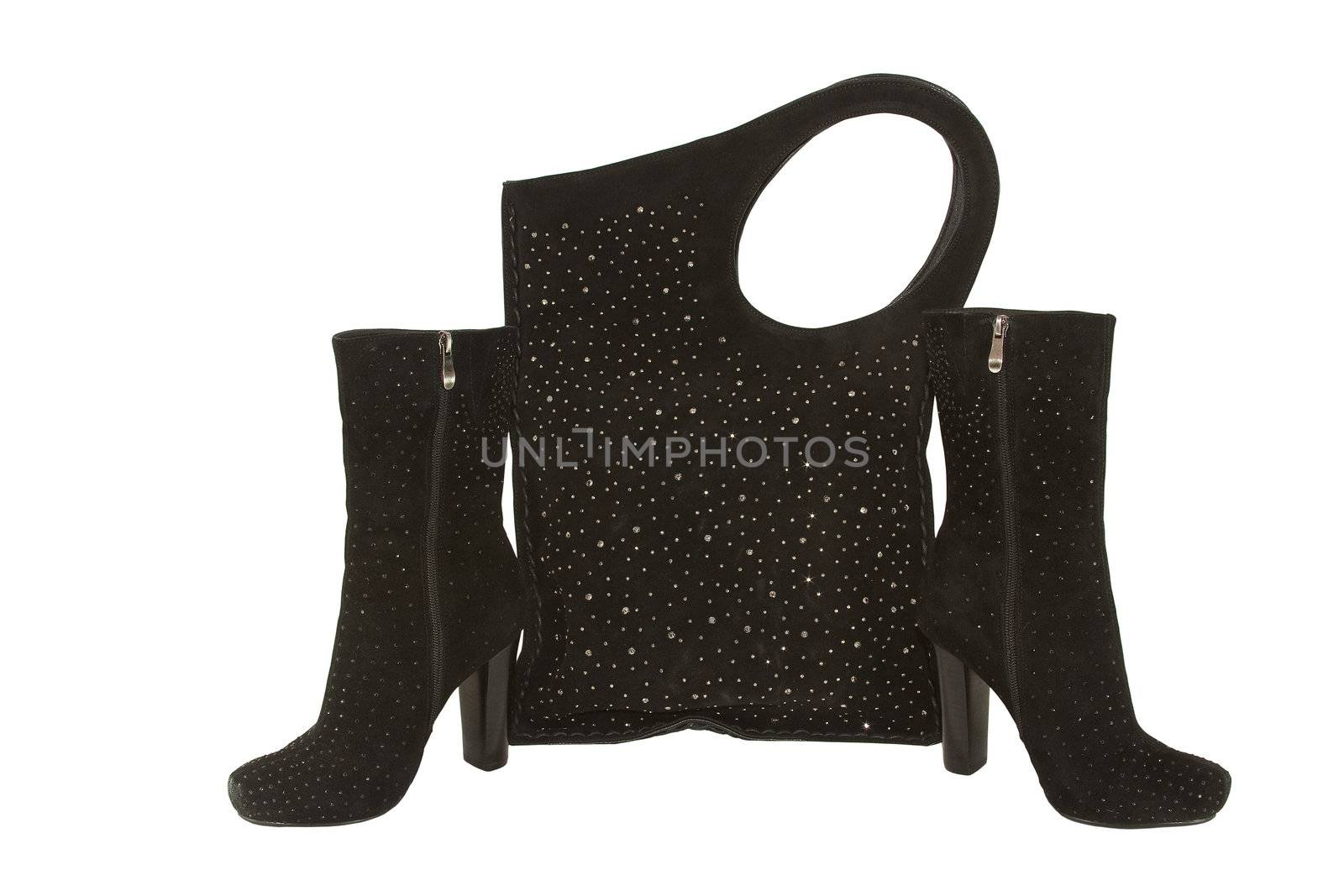 Pair of stylish female suede boots and a suede bag with costume jewellery isolated