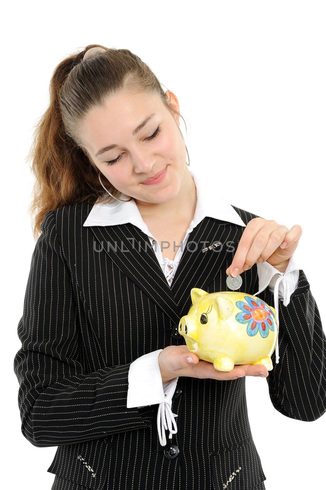 Young happy woman putting money in the piggybank over white background
