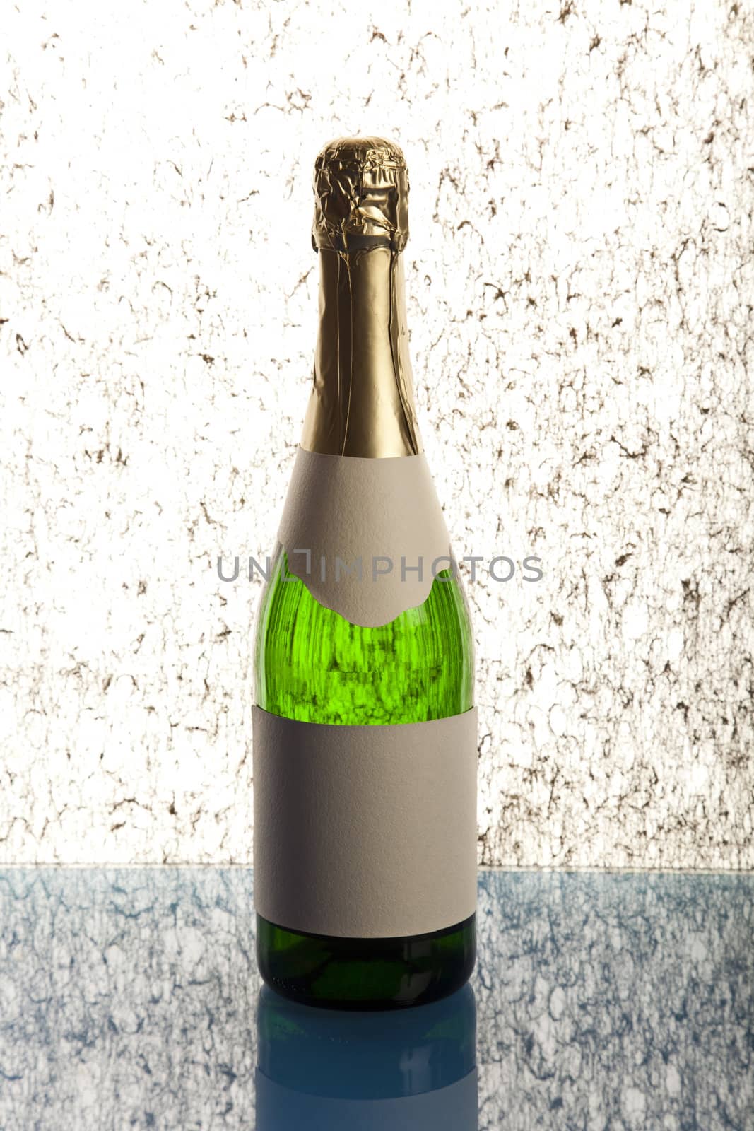 Beautiful big green bottle of chilled champagne on a delicate background