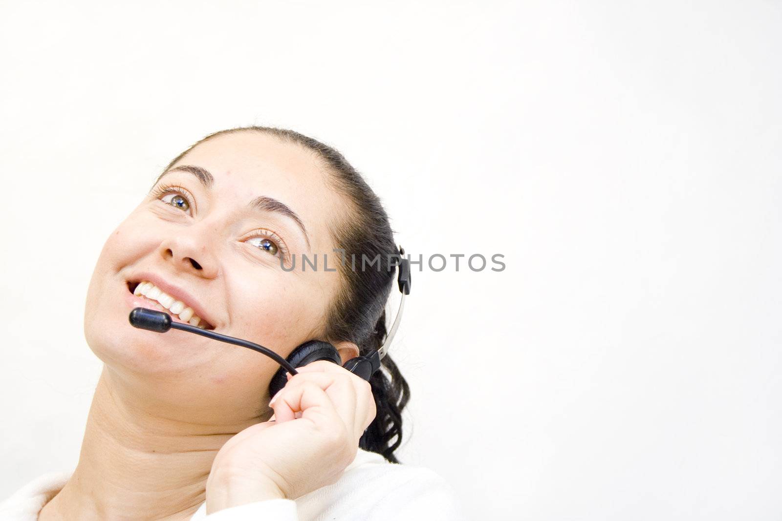 Happy young woman on headset telephone smiling