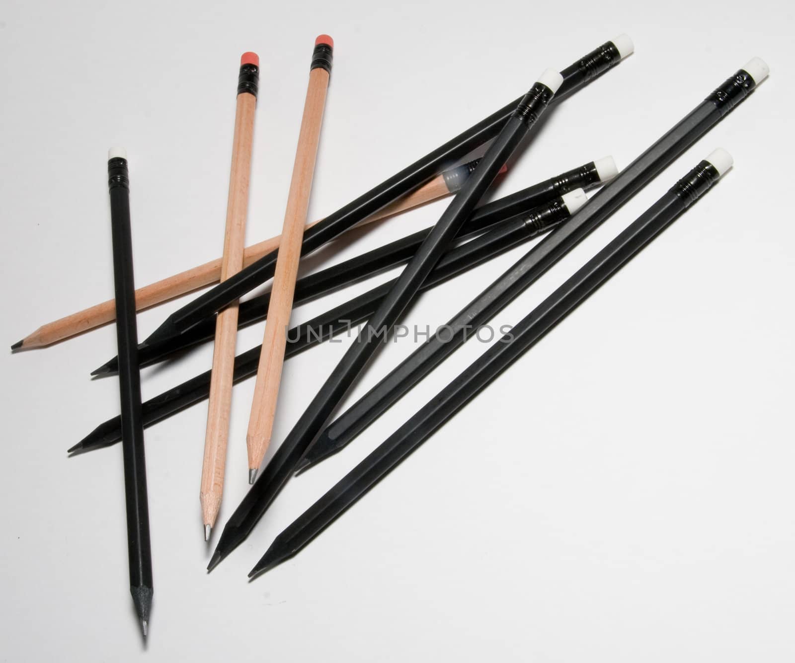 Many black pencils on a white background