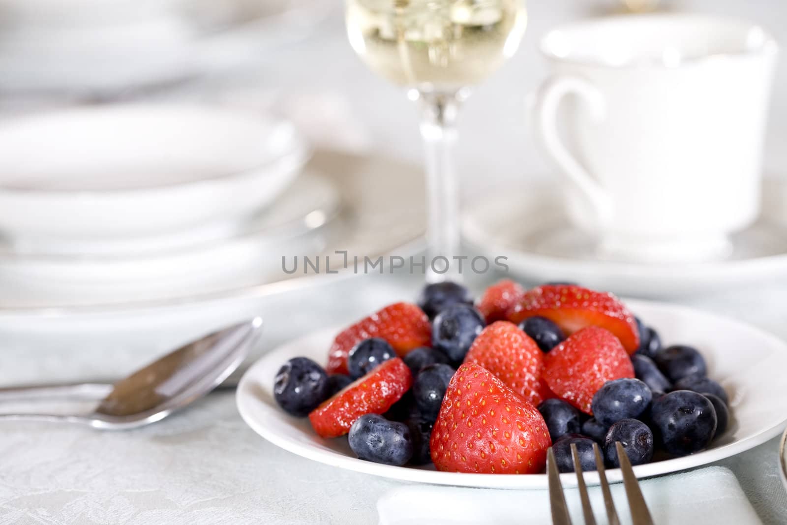 Fresh blueberries and strawberries on table