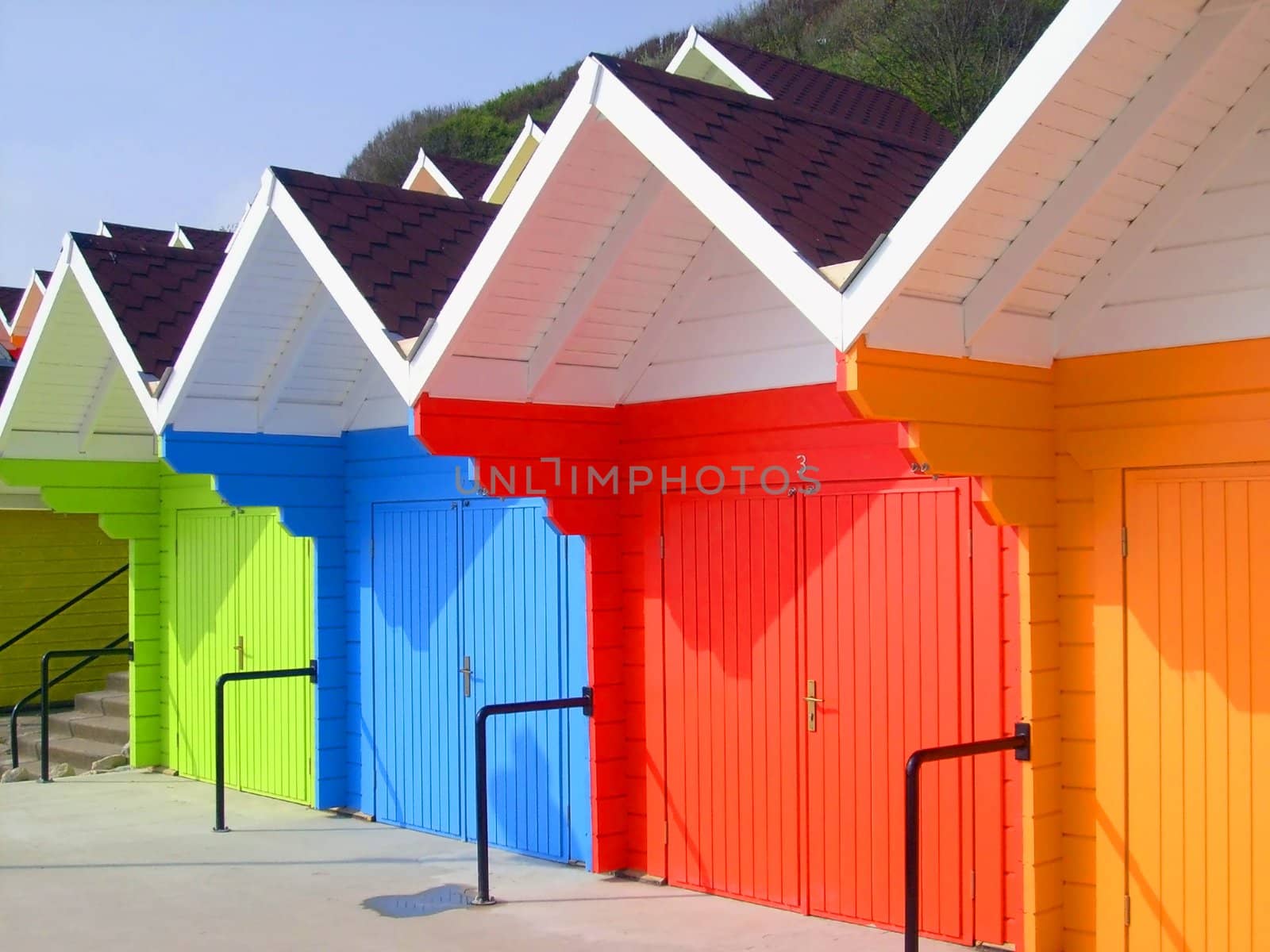 Colorful beach chalets by seaside by speedfighter