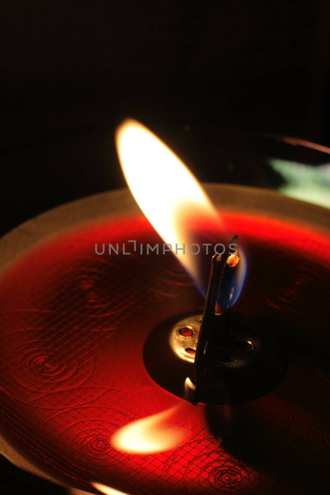 Red candle in dark room