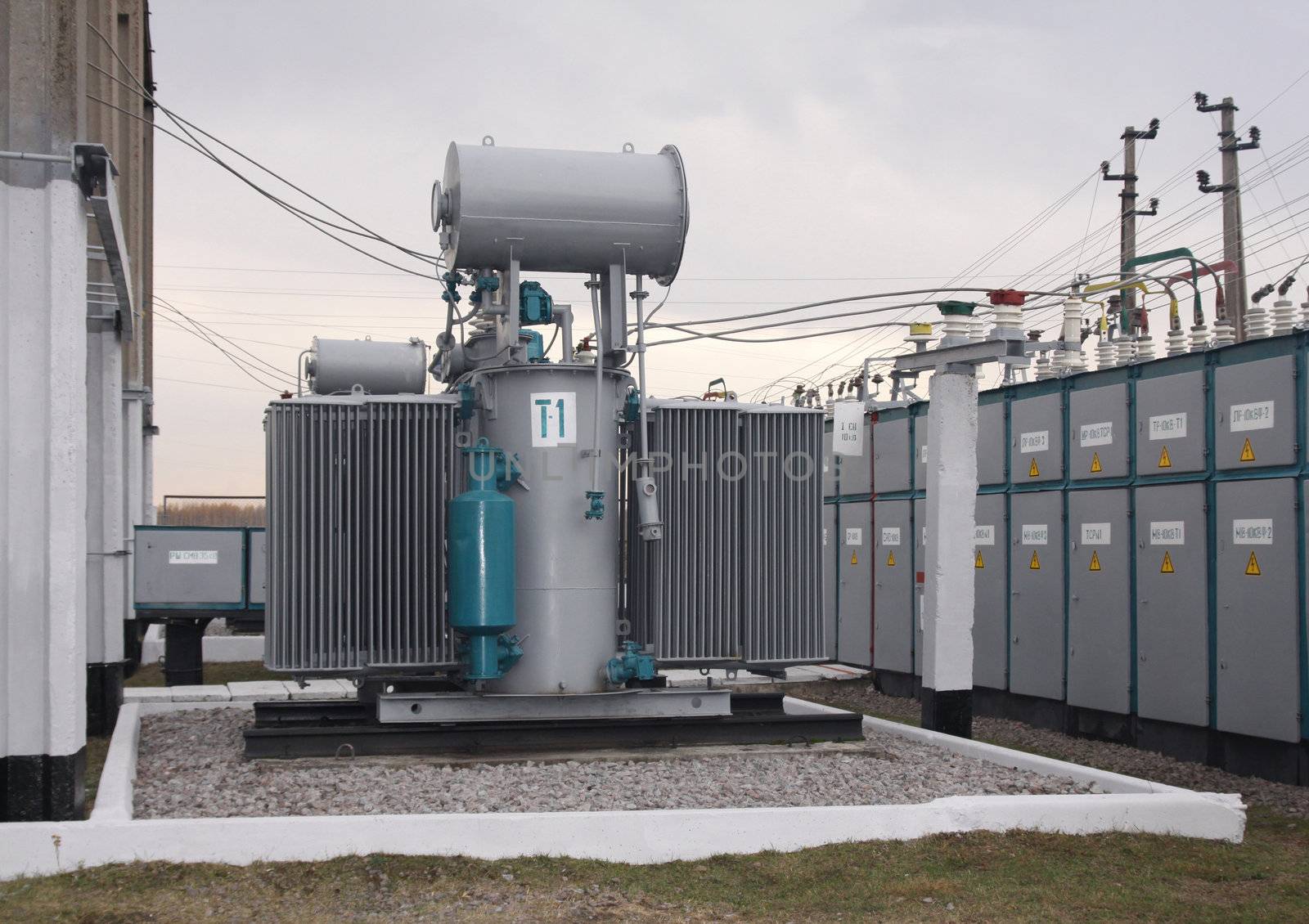 Power transformer in a distribution substation separated from another one by a wall
