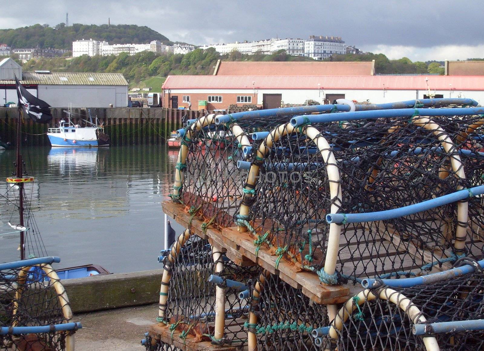 Lobster pots on quayside in harbor scene, Scarborough, England.