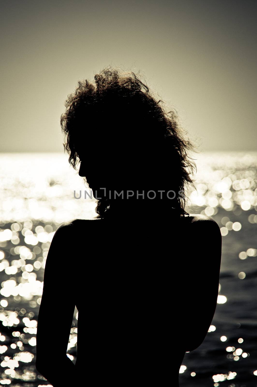 Silhouette of young woman in the water