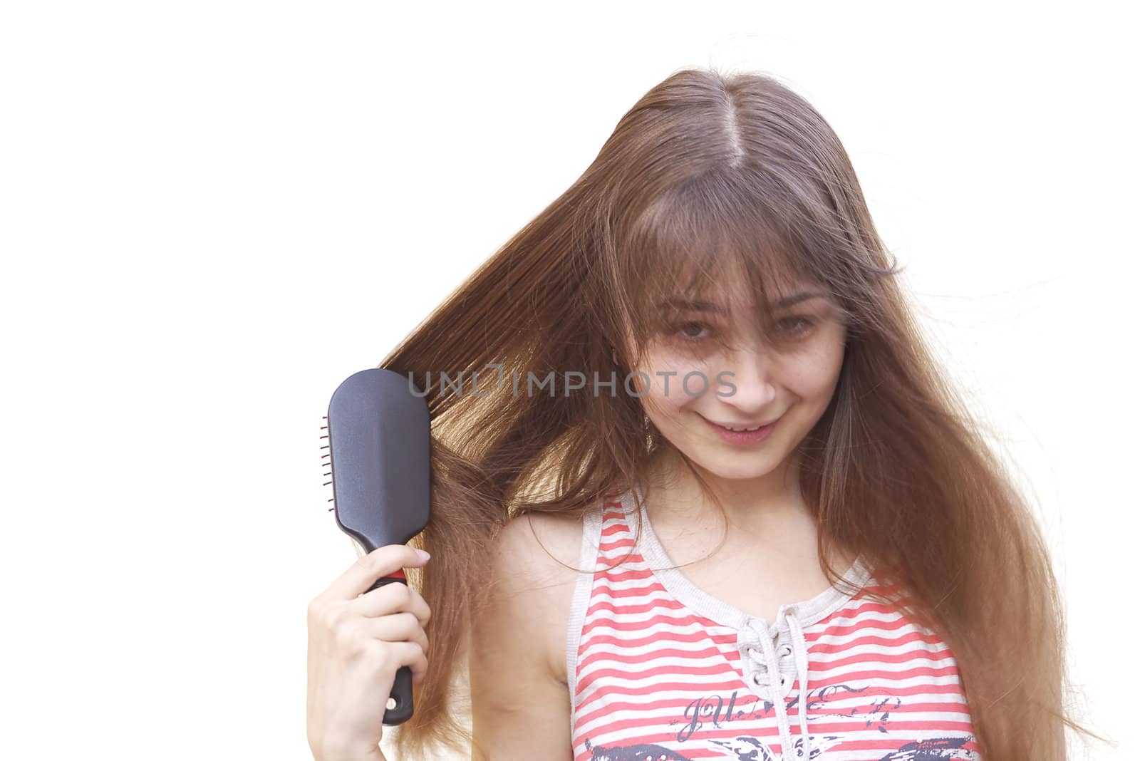 Young girl brushing her long dark hair