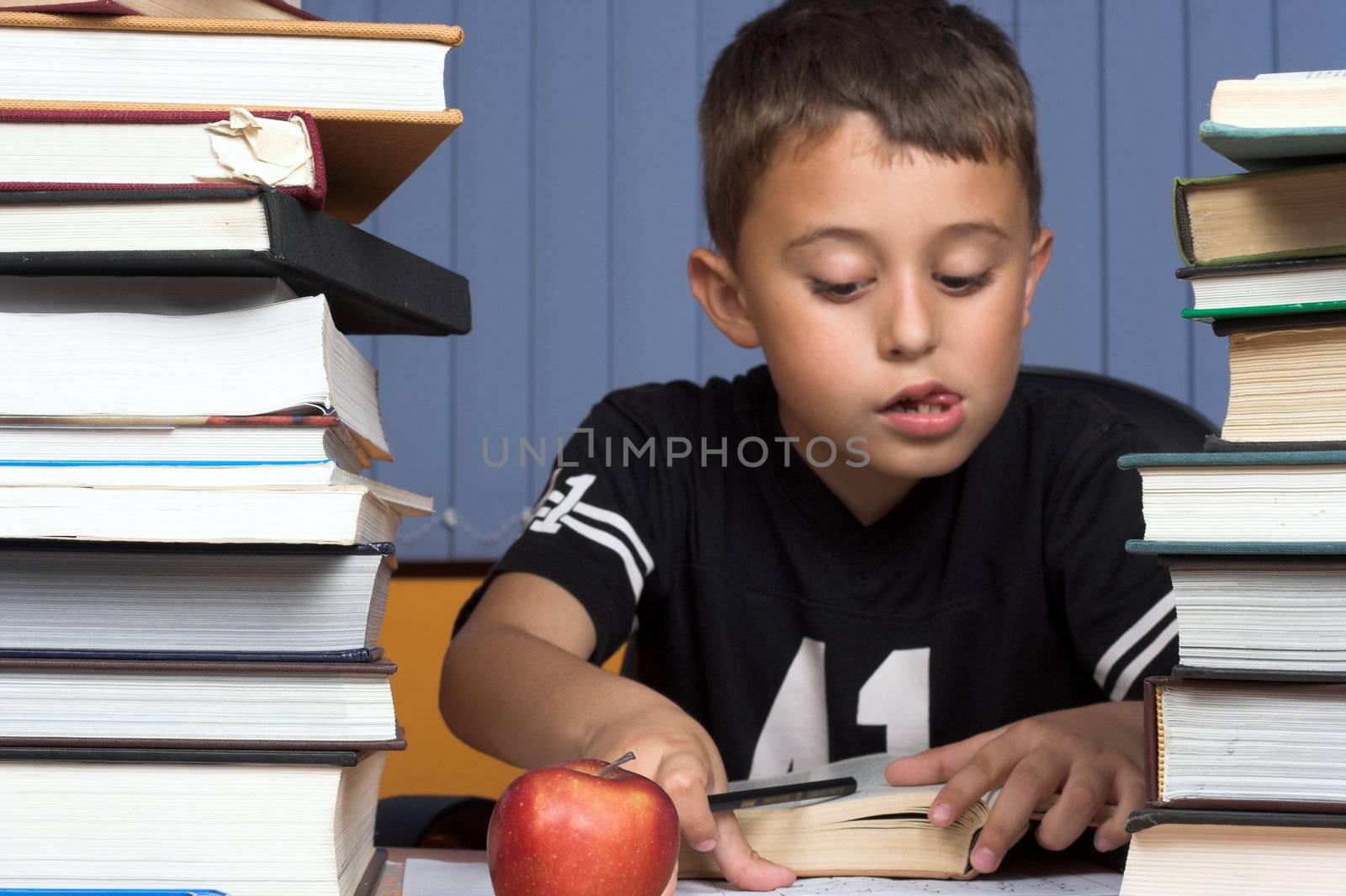 A young schoolboy write his  homework
