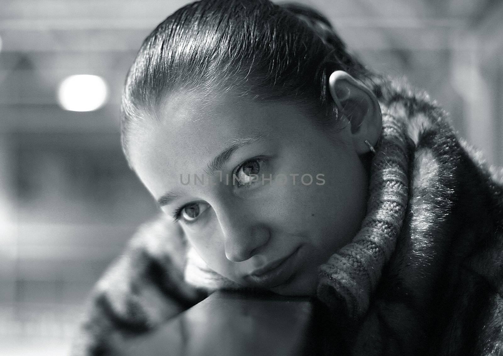 The young girl with a gentle smile close-up. b/w+blue tone