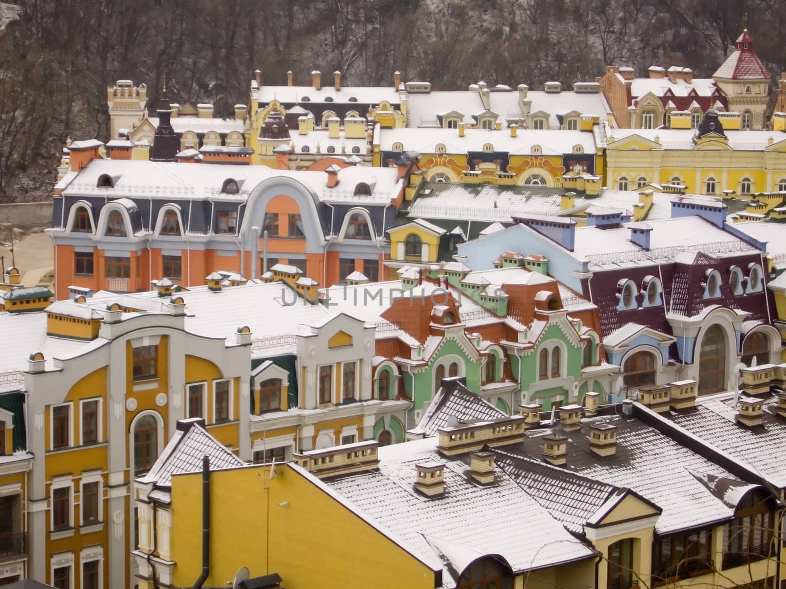 Roofs of restored buildings covered with snow