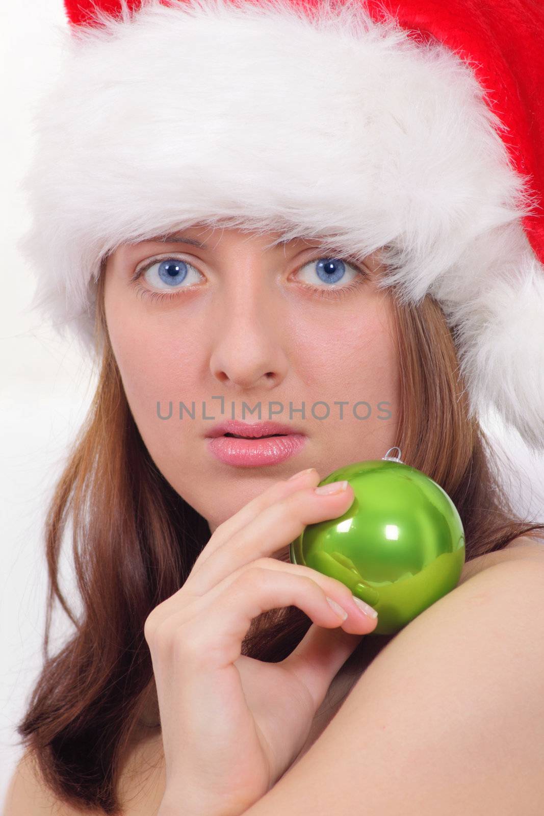 Portrait of the nice girl in a red cap with a green ball