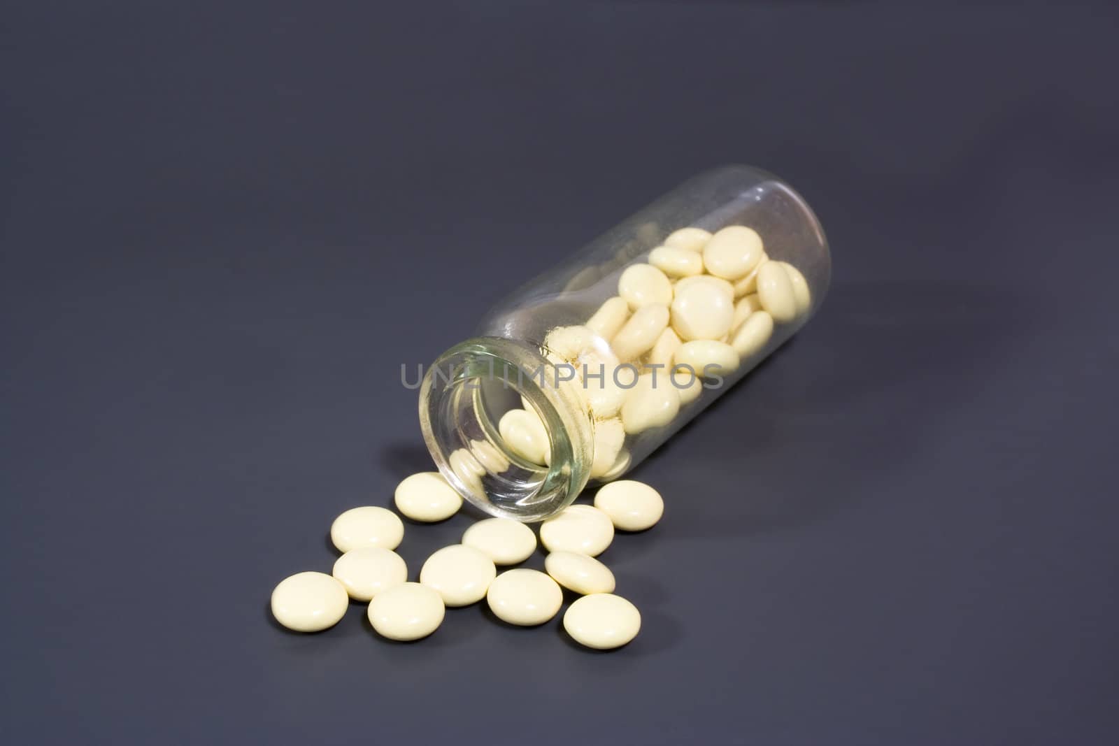 group of yellow pill in the glass vial