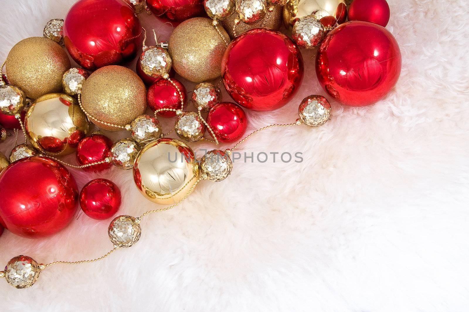 Elegant Christmas baubles with stars, angels and gold ribons on a slightly textured reflective surface
