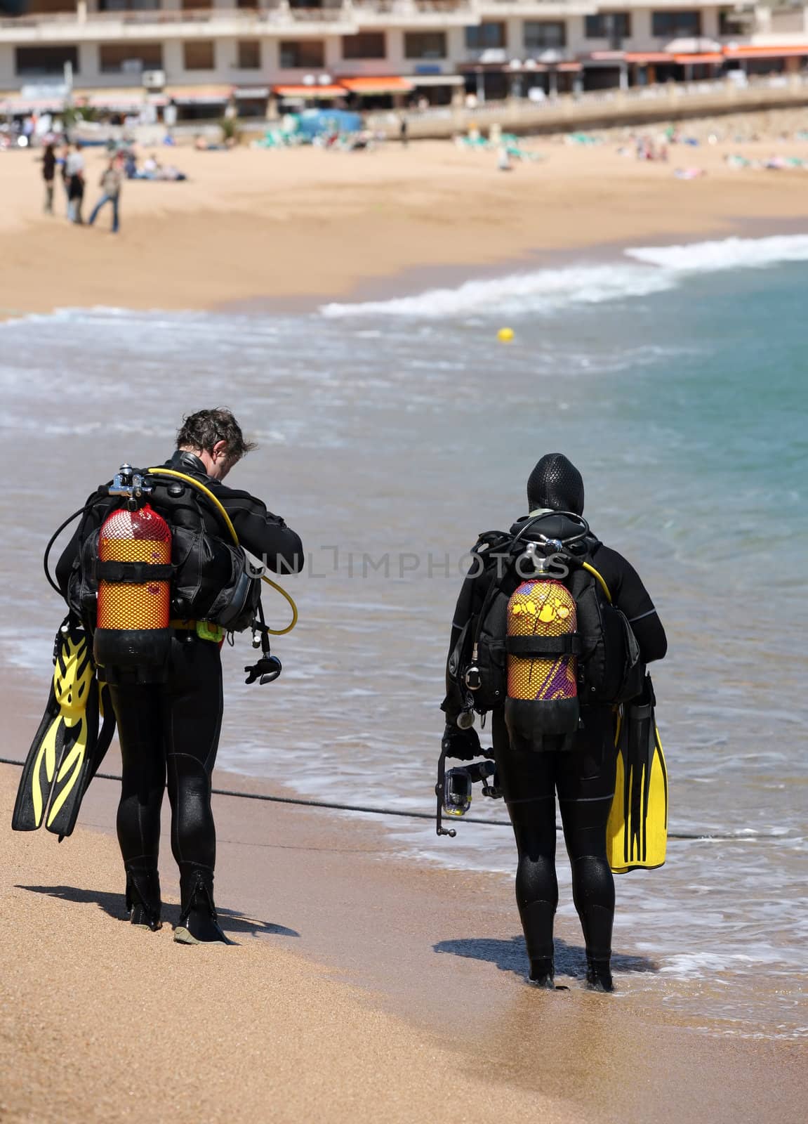 Two frogmens with aqualungs on a coast of the mediterranean sea. Spain