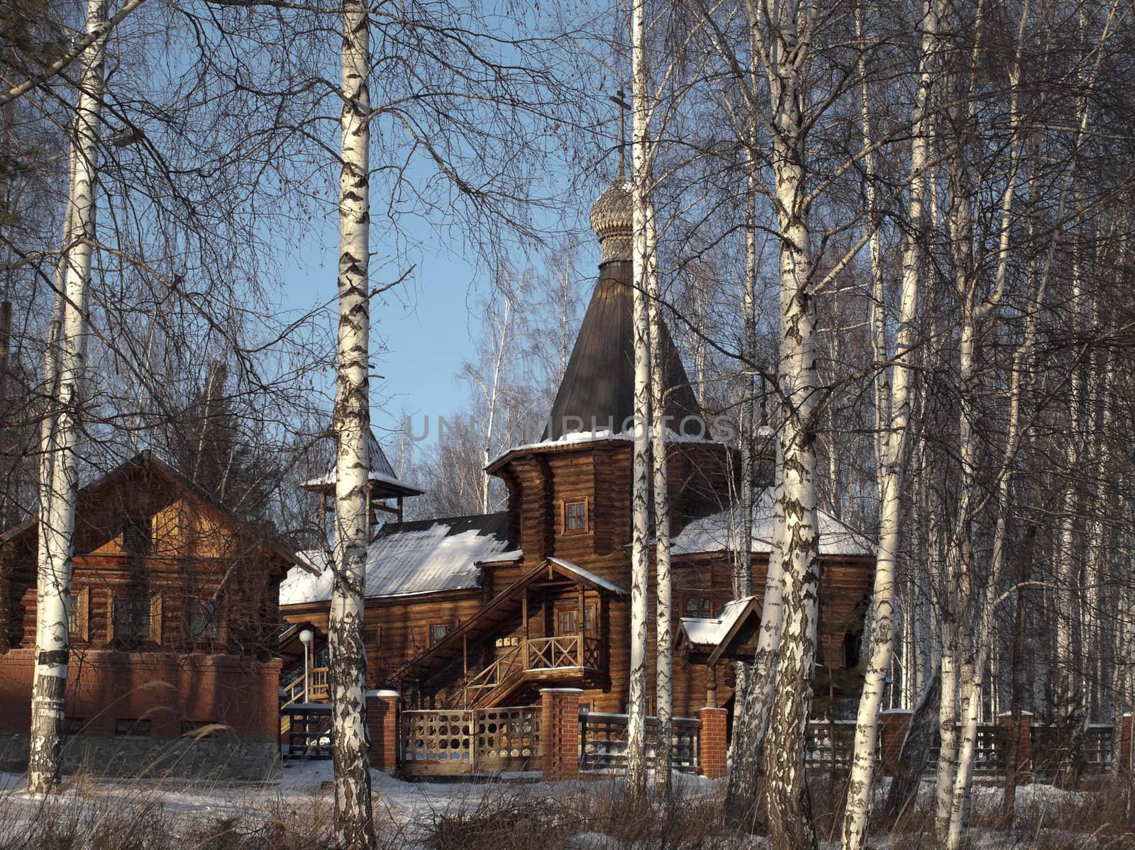  The wooden church located in a birchwood. The city of Novouralsk. Sverdlovsk area. Winter.
