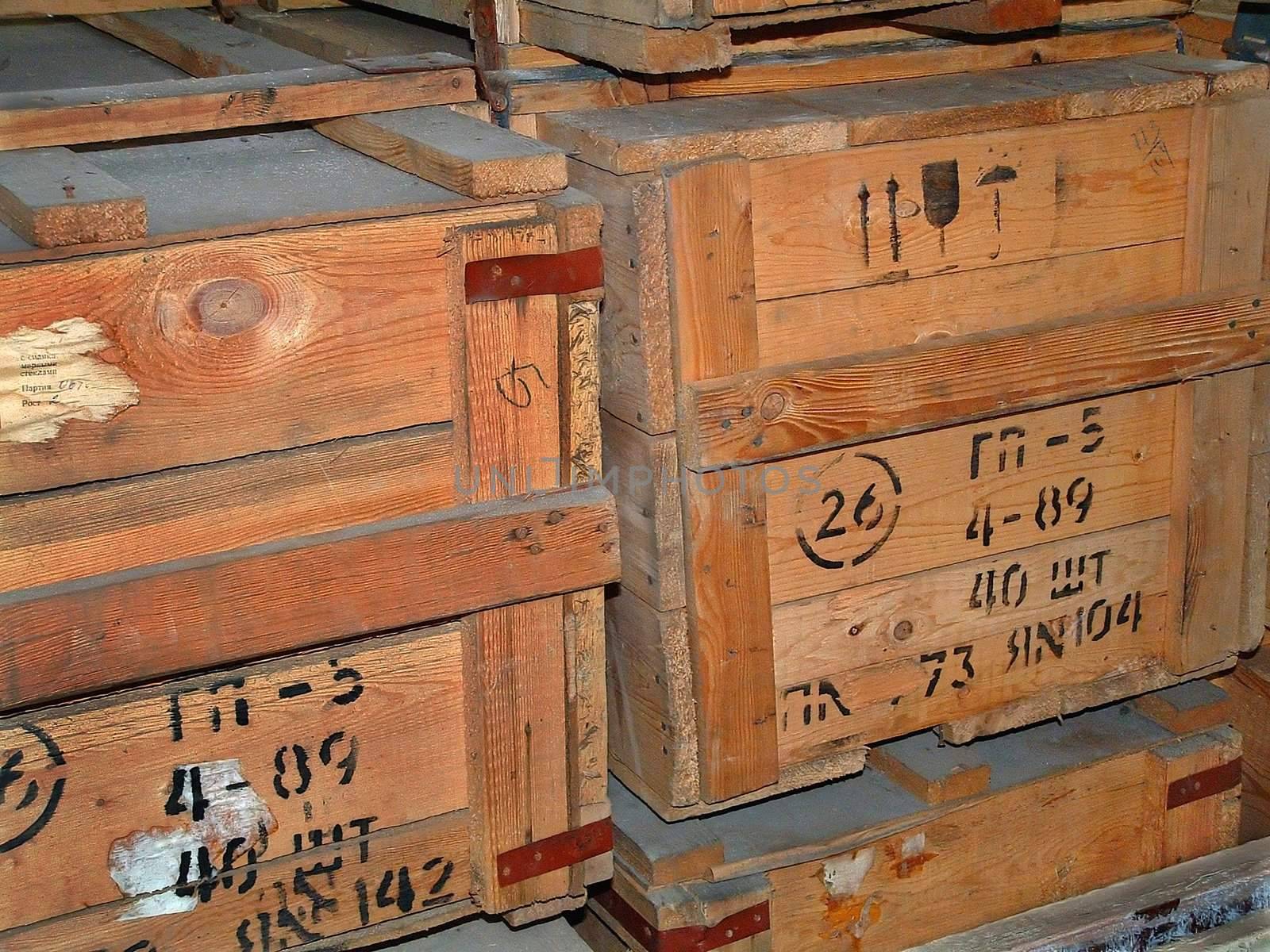 The image of old wooden boxes with gas masks in a military warehouse