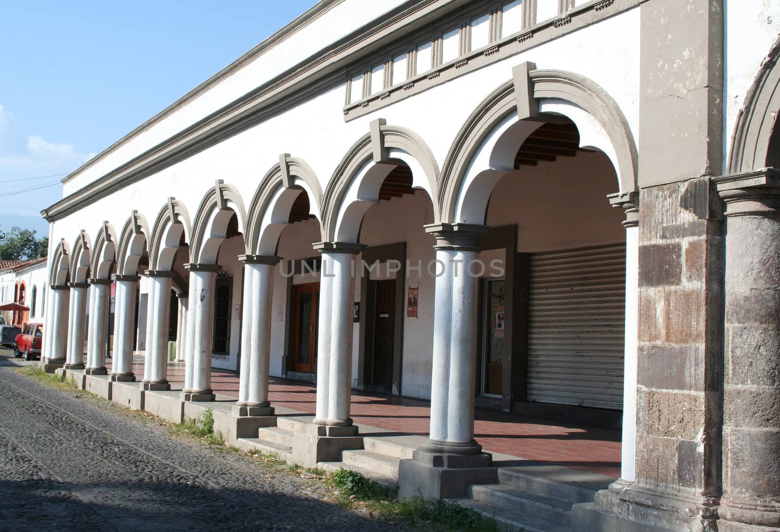 old mexican street front building arches