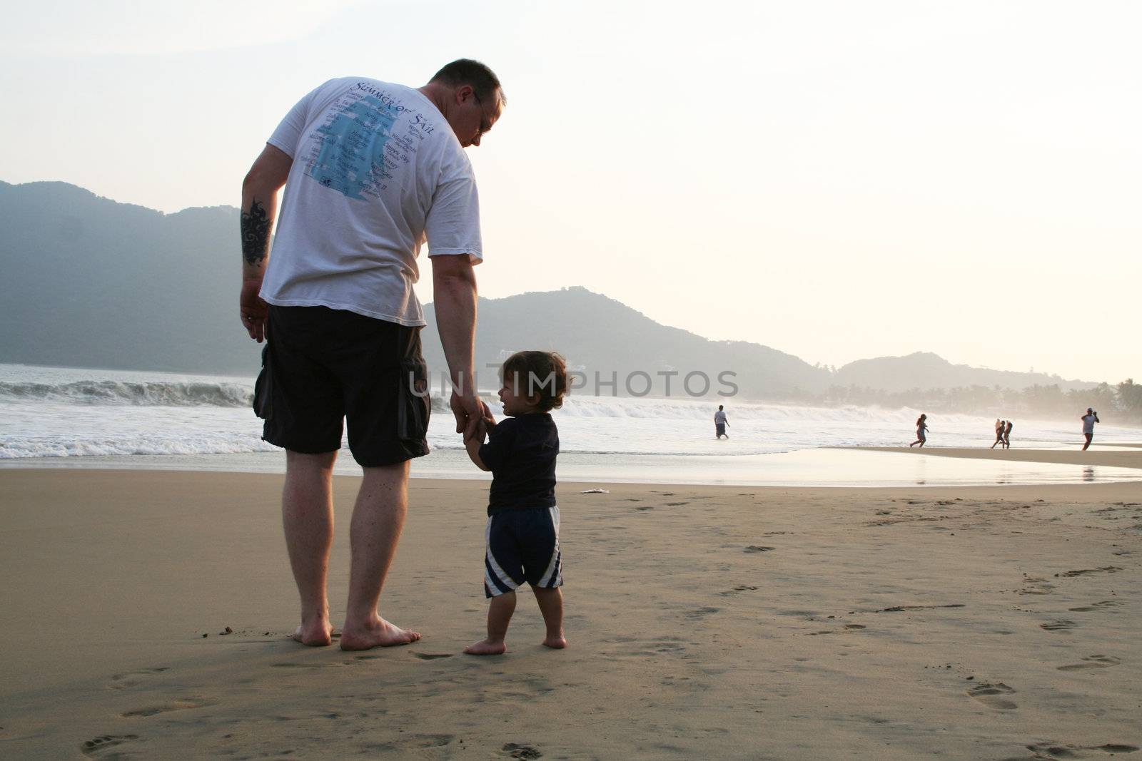 Father and son together on beach