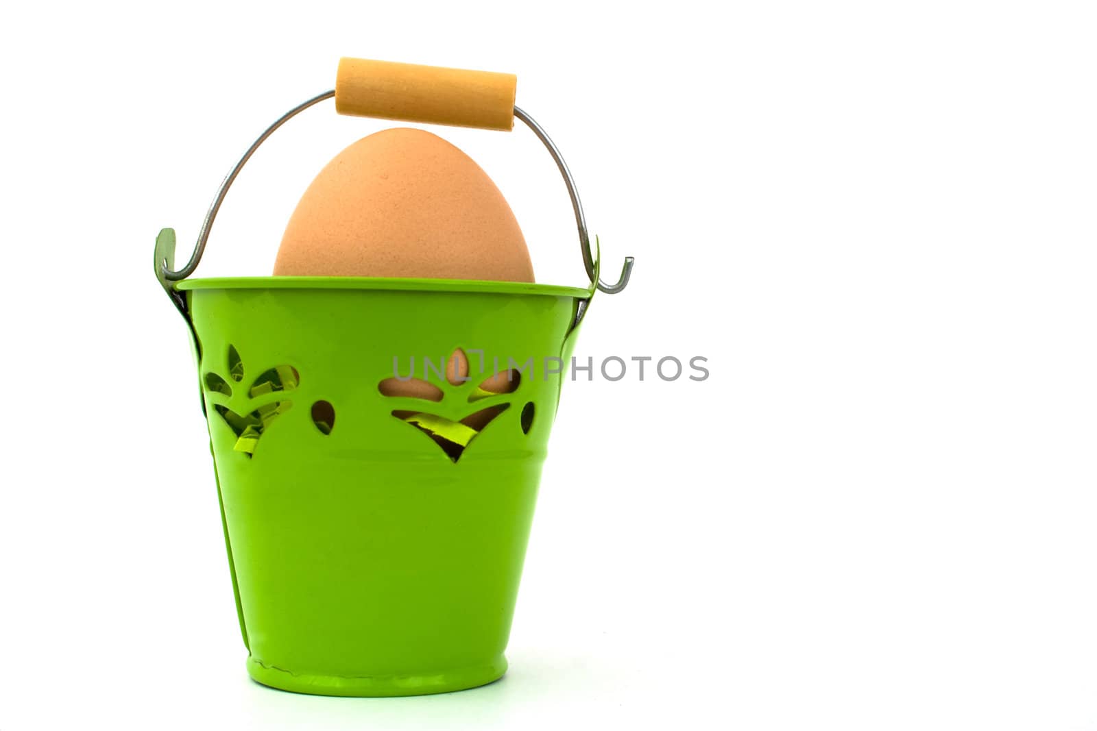 Uncolored egg in green basket, on white background.