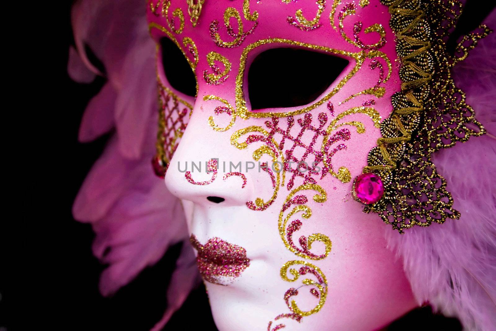 Violet-pink Venetian mask with decoration on black