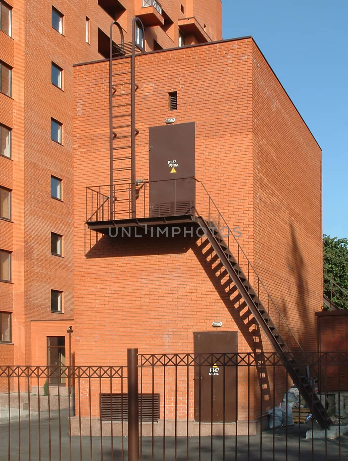 Electric substation in a court yard of the inhabited multi-storey house from a red brick