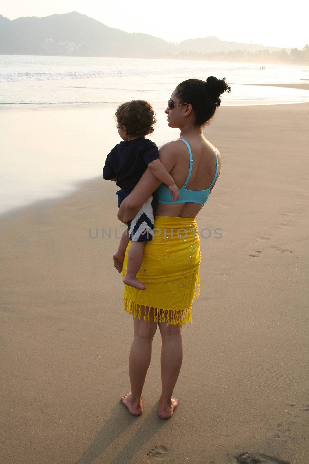 Mother and baby boy together on beach