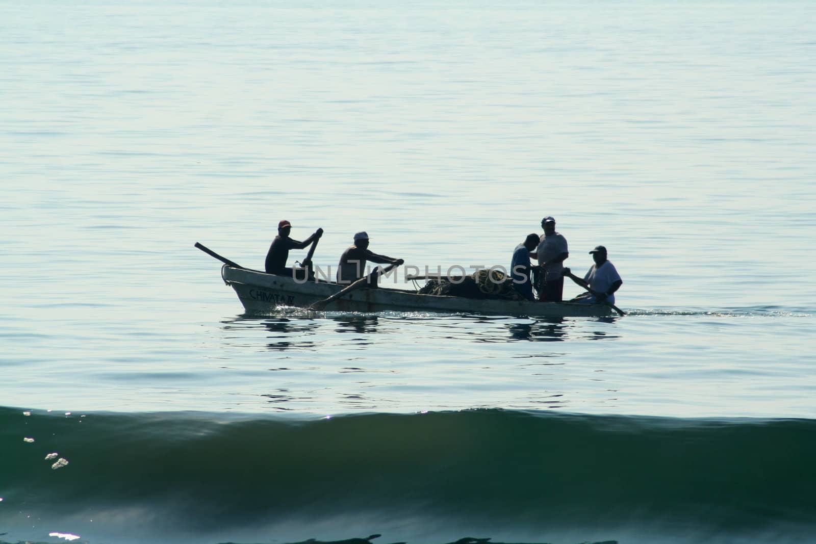 Fishermen in a boat rowing