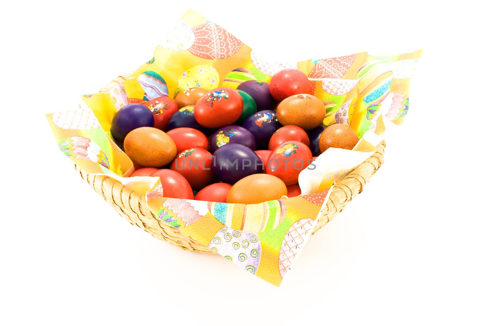 Wooden basket full of colorful Easter eggs. Isolated.