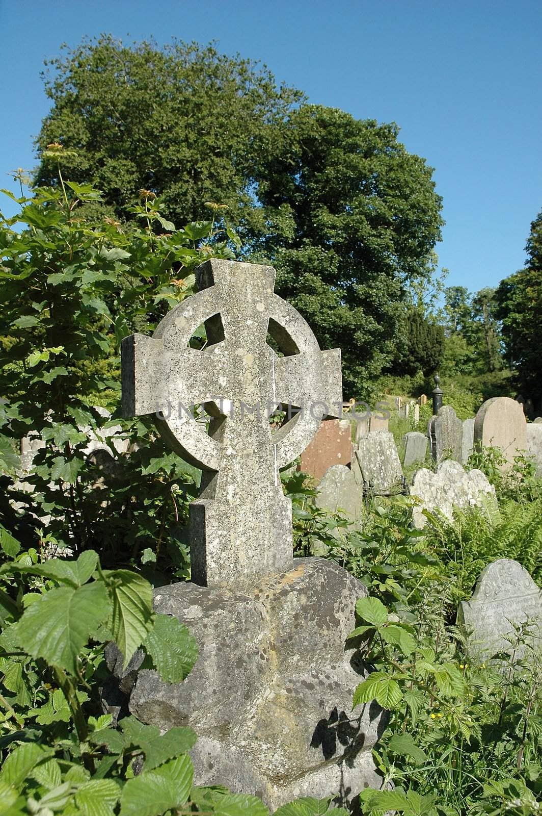 Celtic cross on a tomb in cemetary