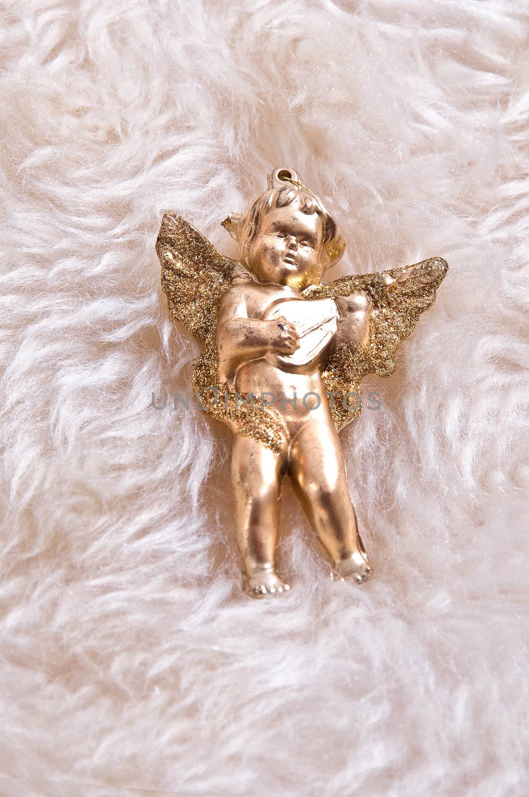 Elegant Christmas baubles with stars, angels and gold ribons on a slightly textured reflective surface