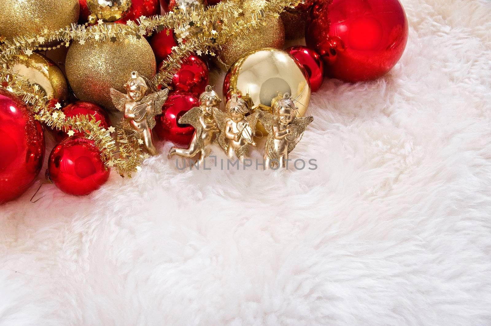 Elegant Christmas baubles with stars, angels and gold ribons on a slightly textured reflective surface