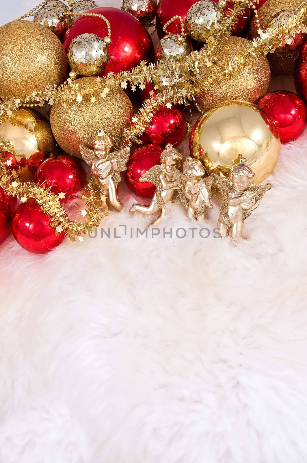 Elegant Christmas baubles with stars, angels and gold ribons on a slightly textured reflective surface