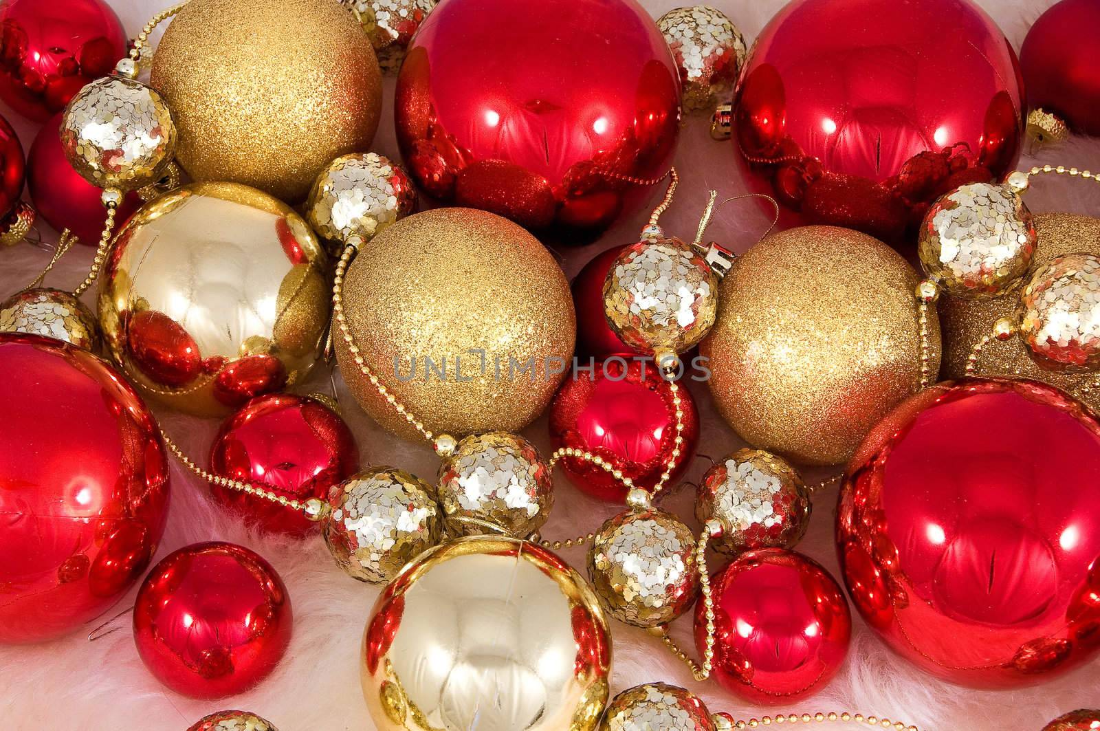 Elegant Christmas baubles with stars, angels and gold ribons on a slightly textured reflective surface