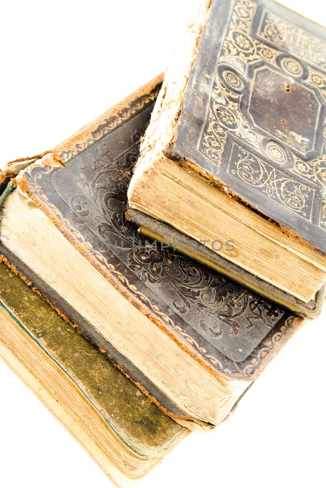 Three closed old books lying one on another. Isolated on white.