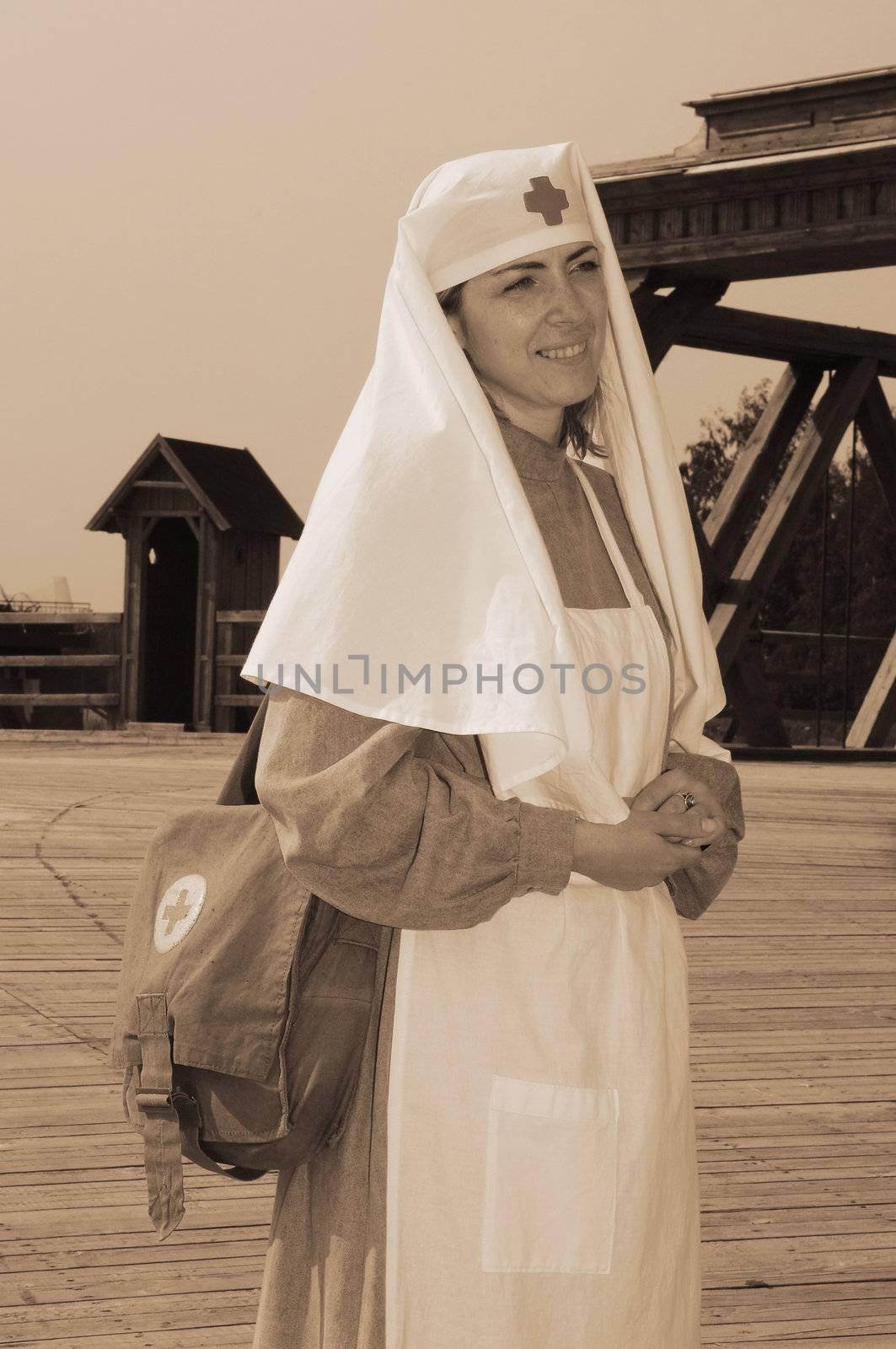 Old style picture with woman in nurse costume. Costume is authentic to the ones weared in time of  World War I.