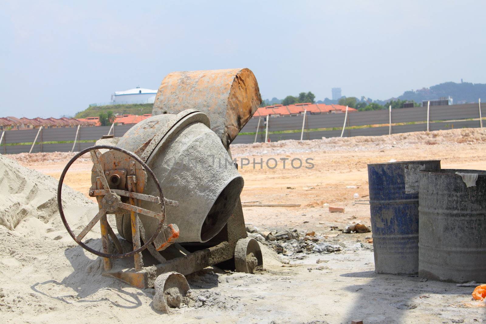 An old concrete mixer at a building site used for mixing cement mortar for brick wall construction 