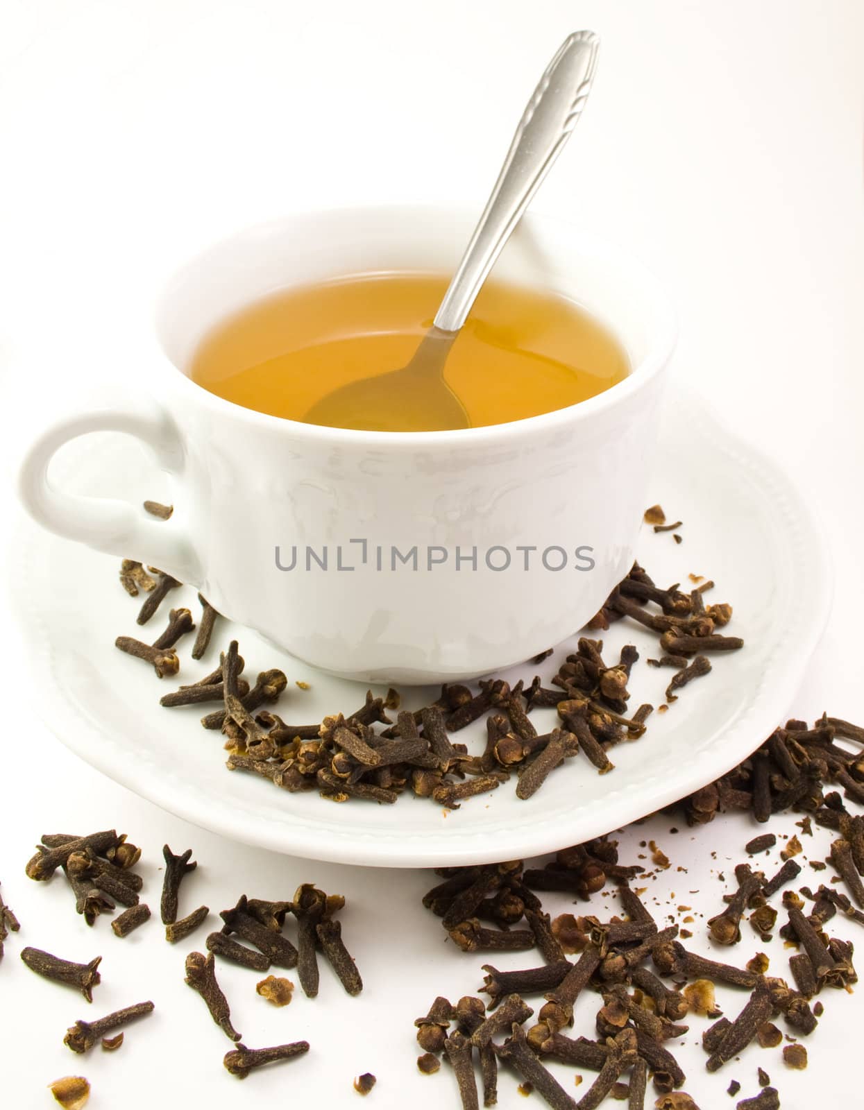 Cup with tea, spoon, plate and decoration