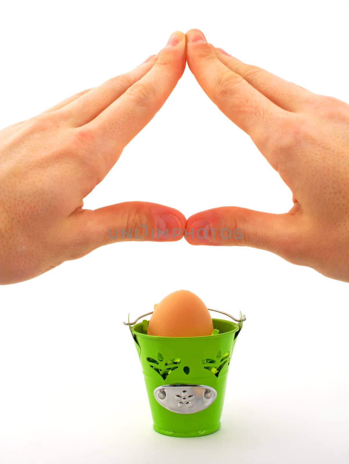 Hands making roof for protection, over egg in basket, on white background.
