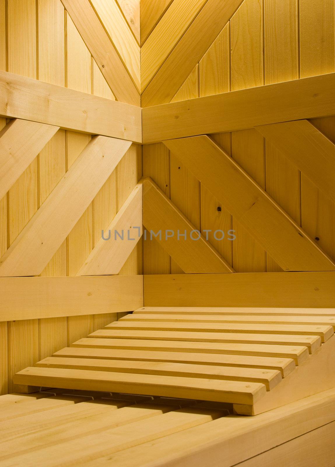 Detail of Finnish sauna. Wooden bench and pillow in it.