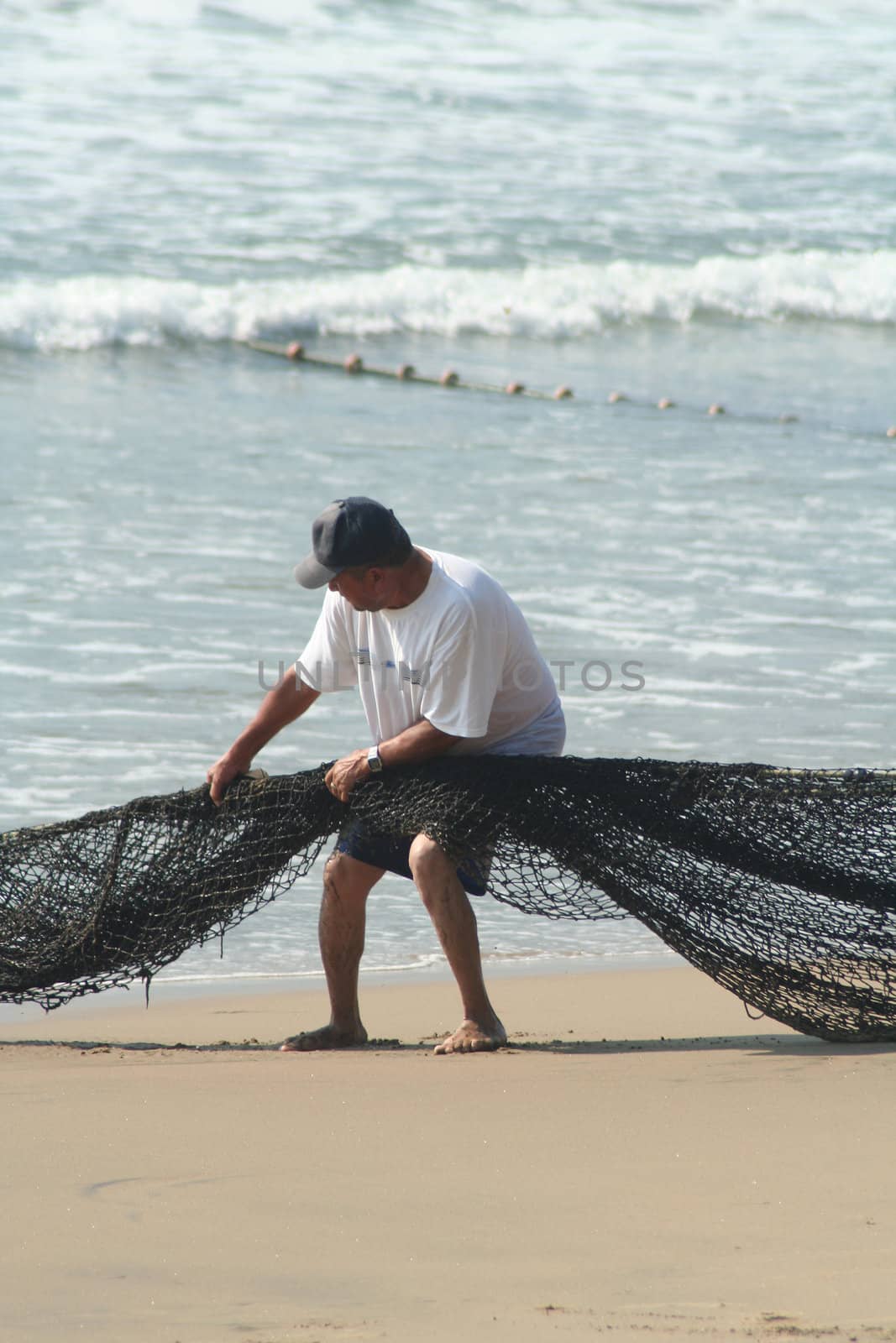 Fishermen pulling in net from the beach