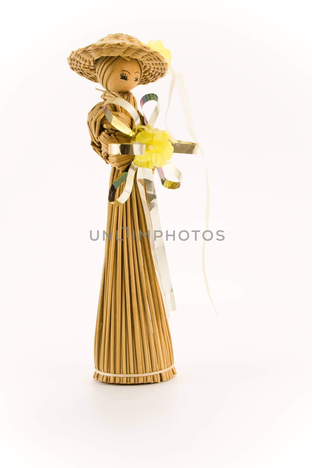 Straw lady holding flower. Isolated on white background.