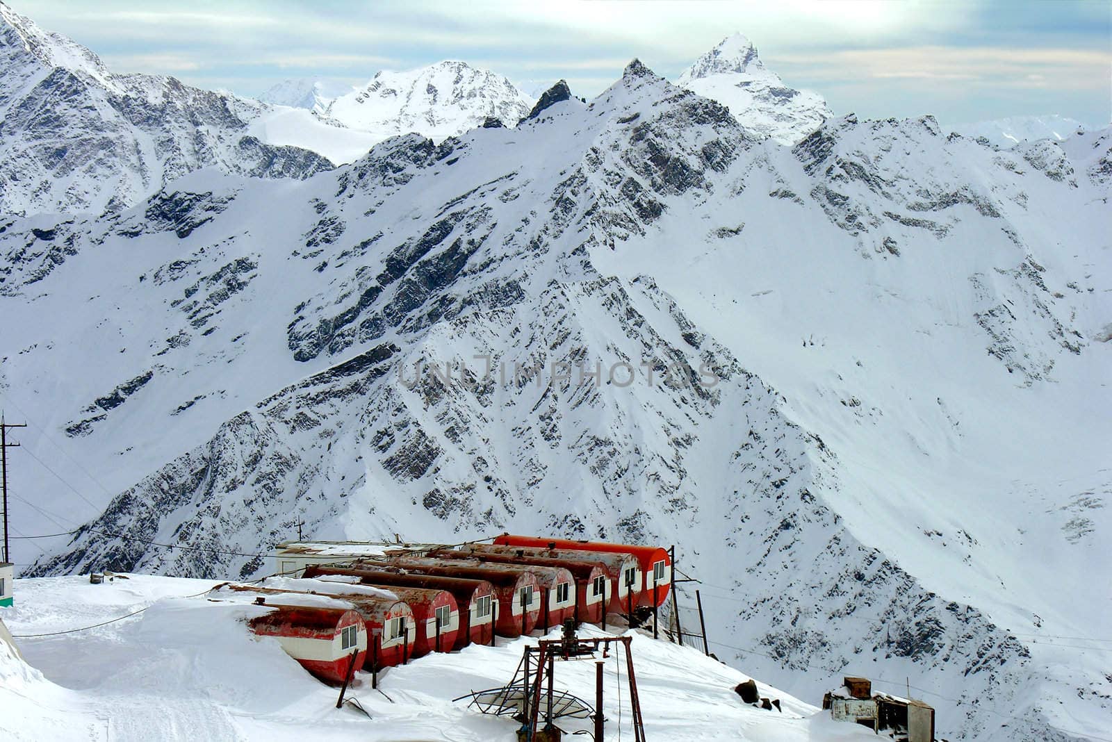 Base of climbers in snow-covered mountains.
          