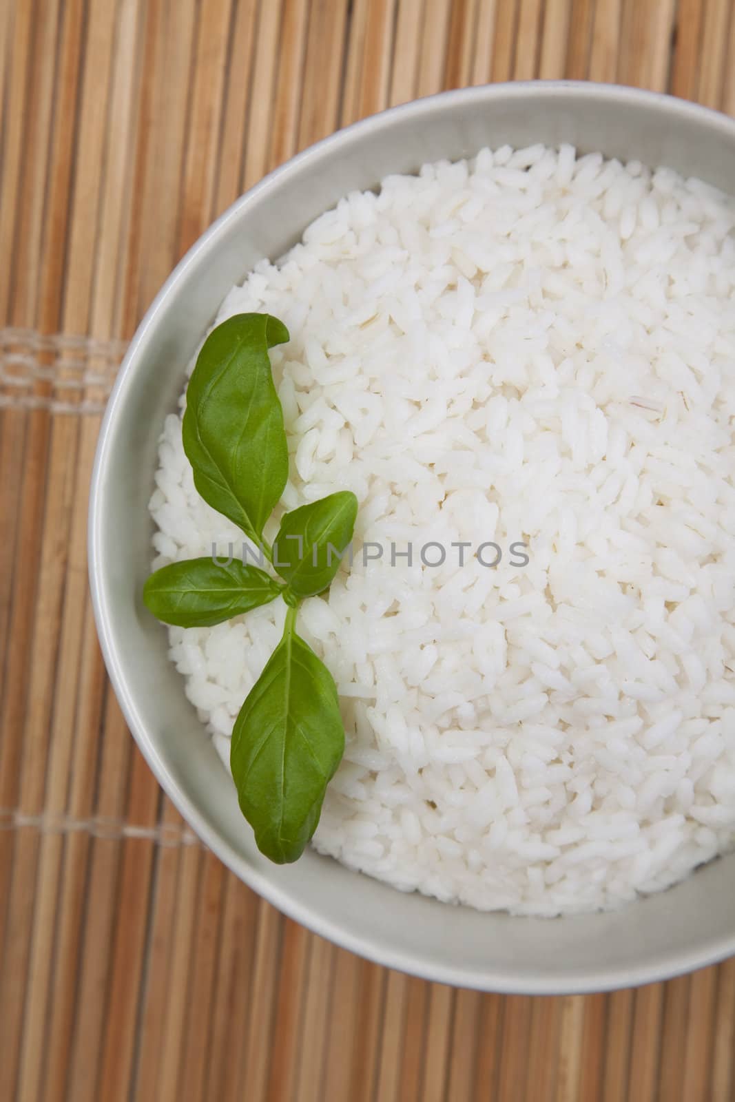 Bowl of white rice on tatami mat by shiffti