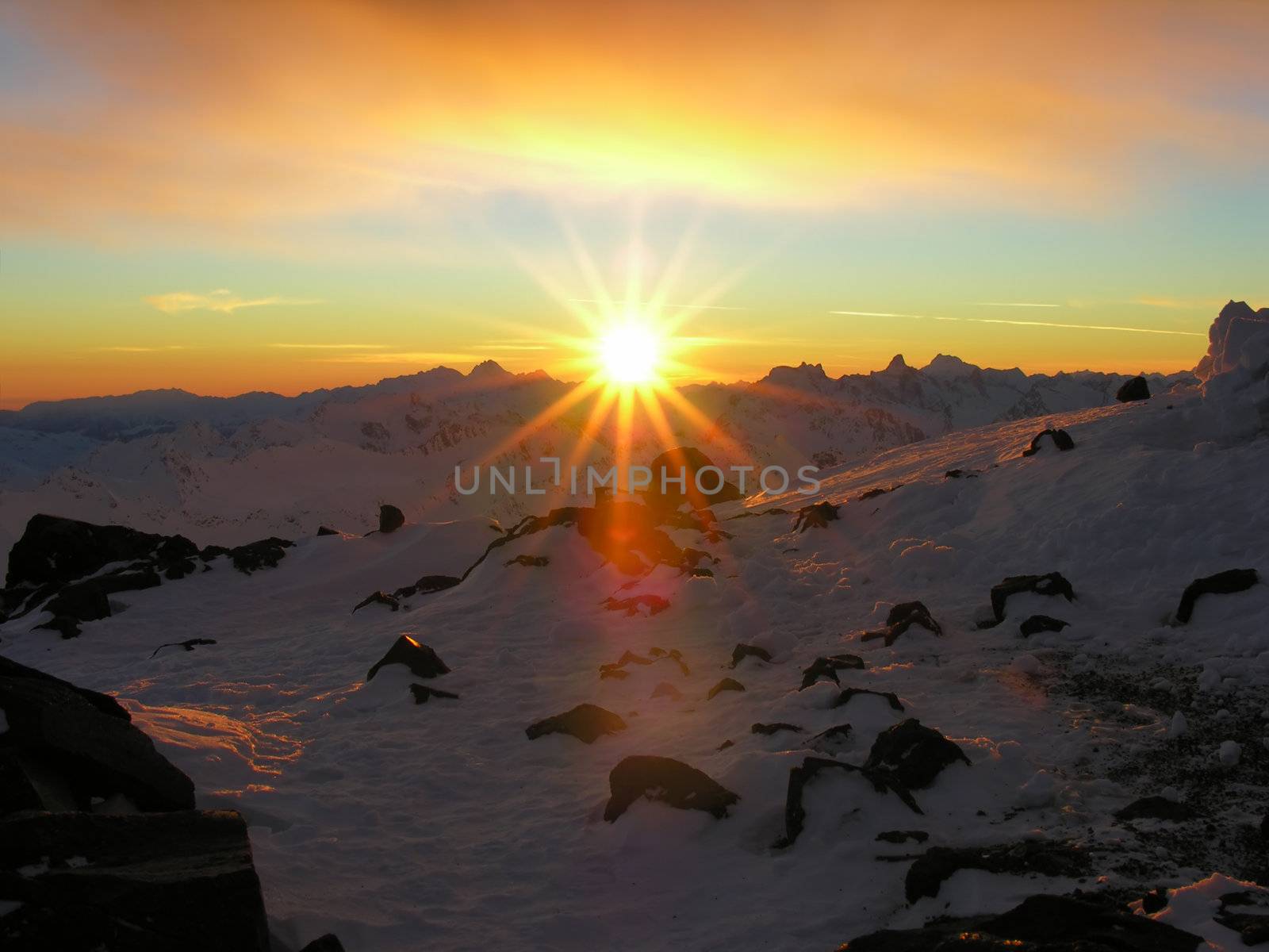 Sunset in snow-covered mountains of Caucasus