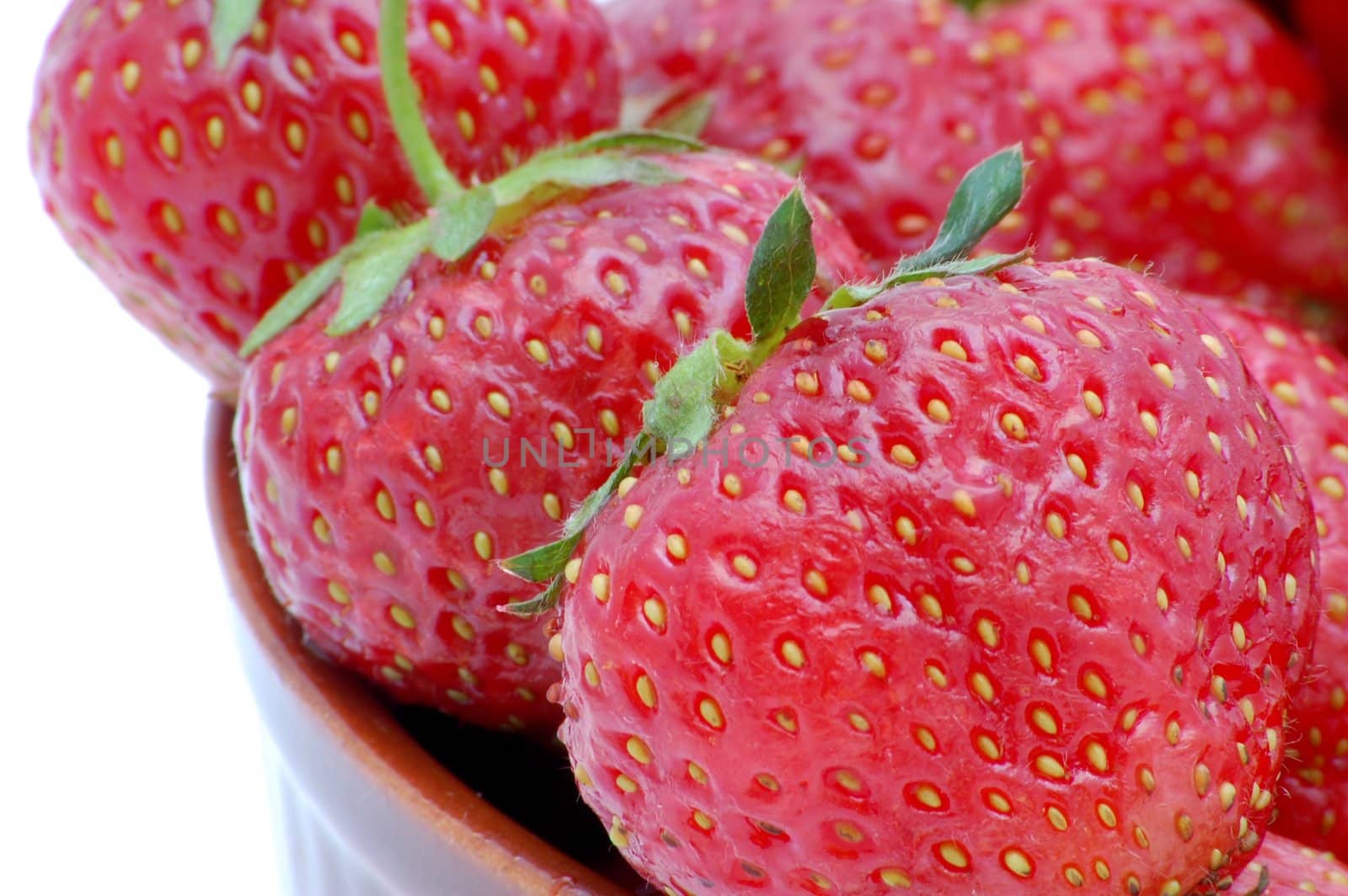 Strawberries in a bowl isolated on the white background